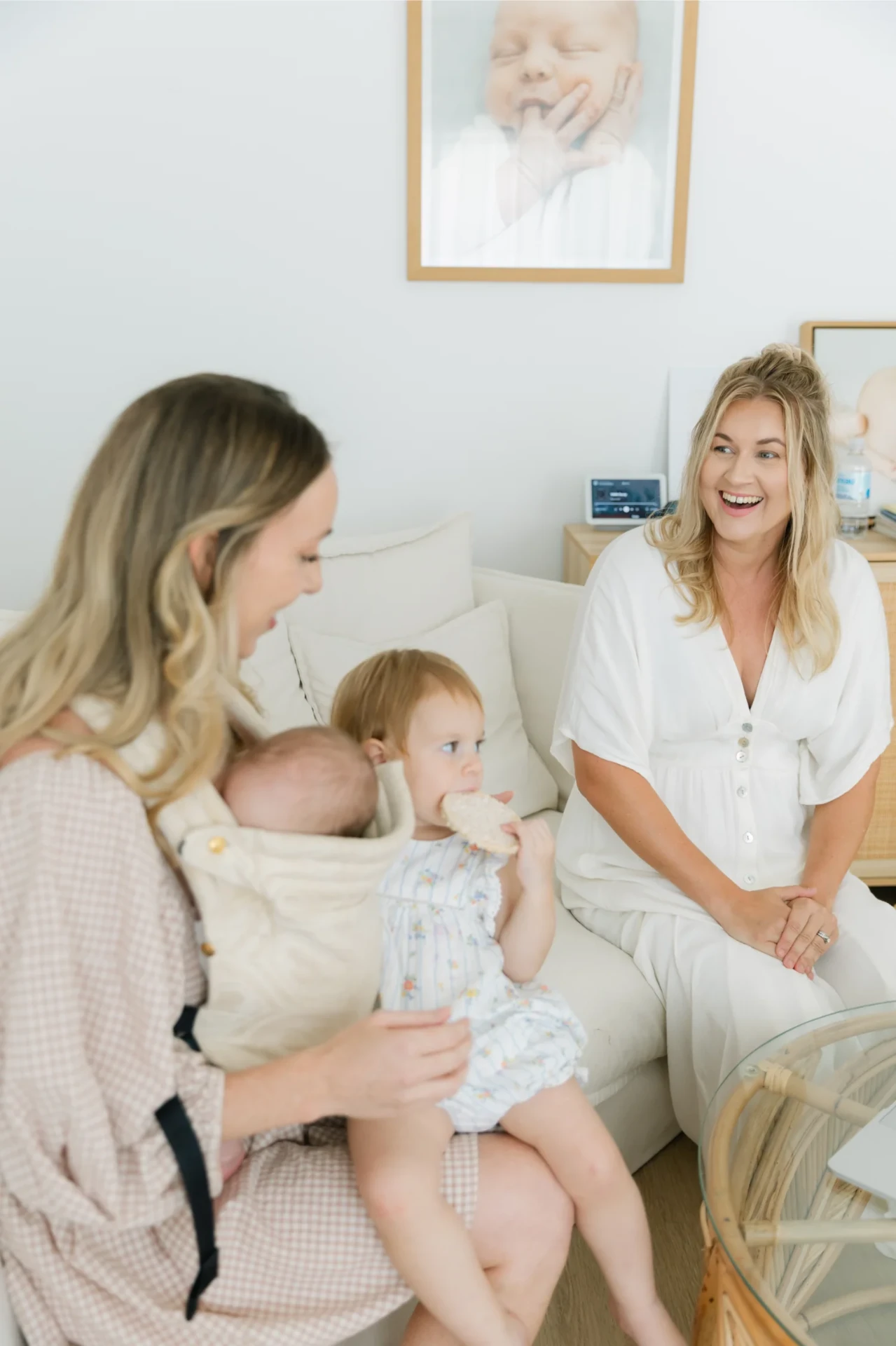 Beck laughing with a mother and her two young children